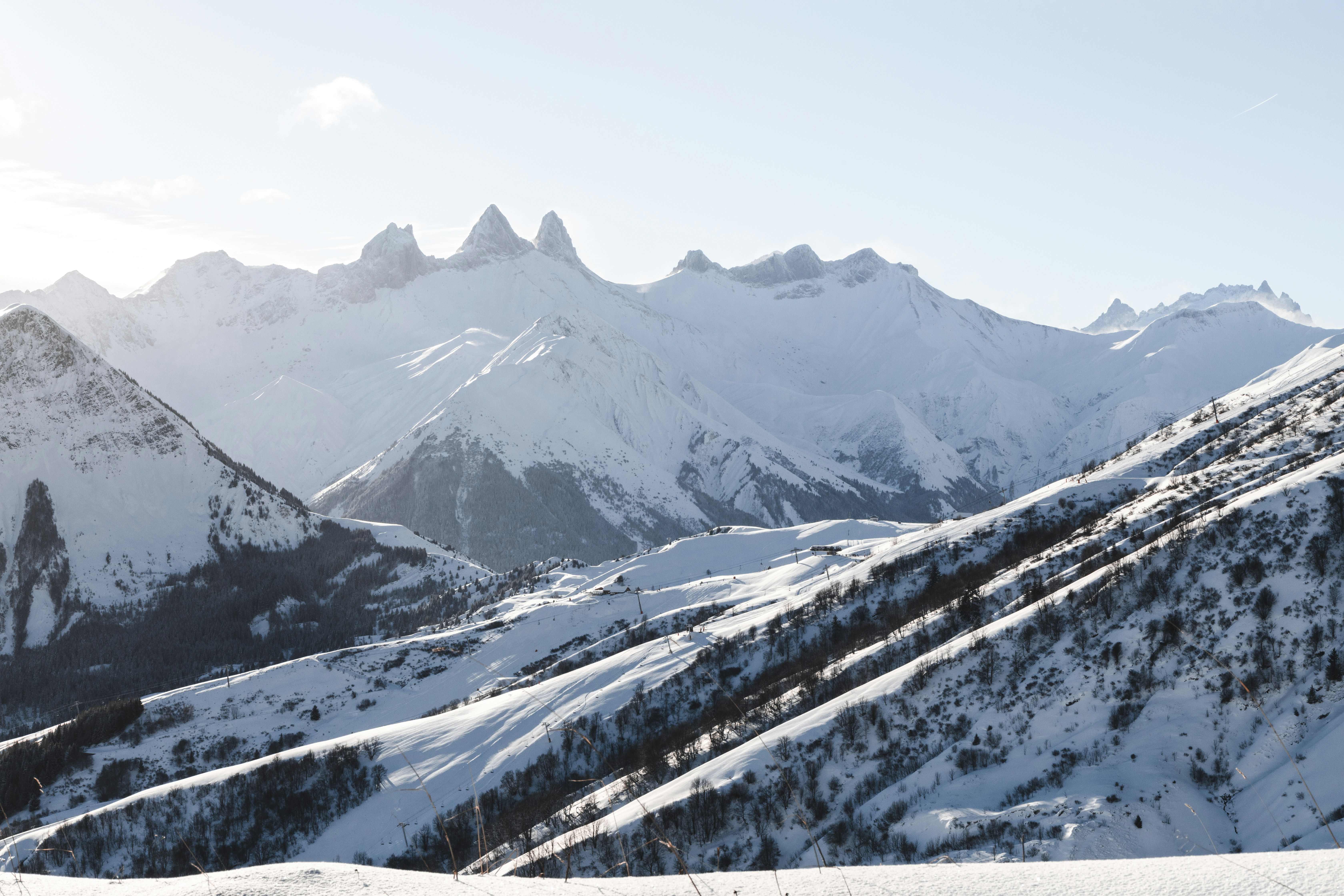 Travel to Val d'Isére - Winter wonderland with snow-capped mountain peaks and clear skies.