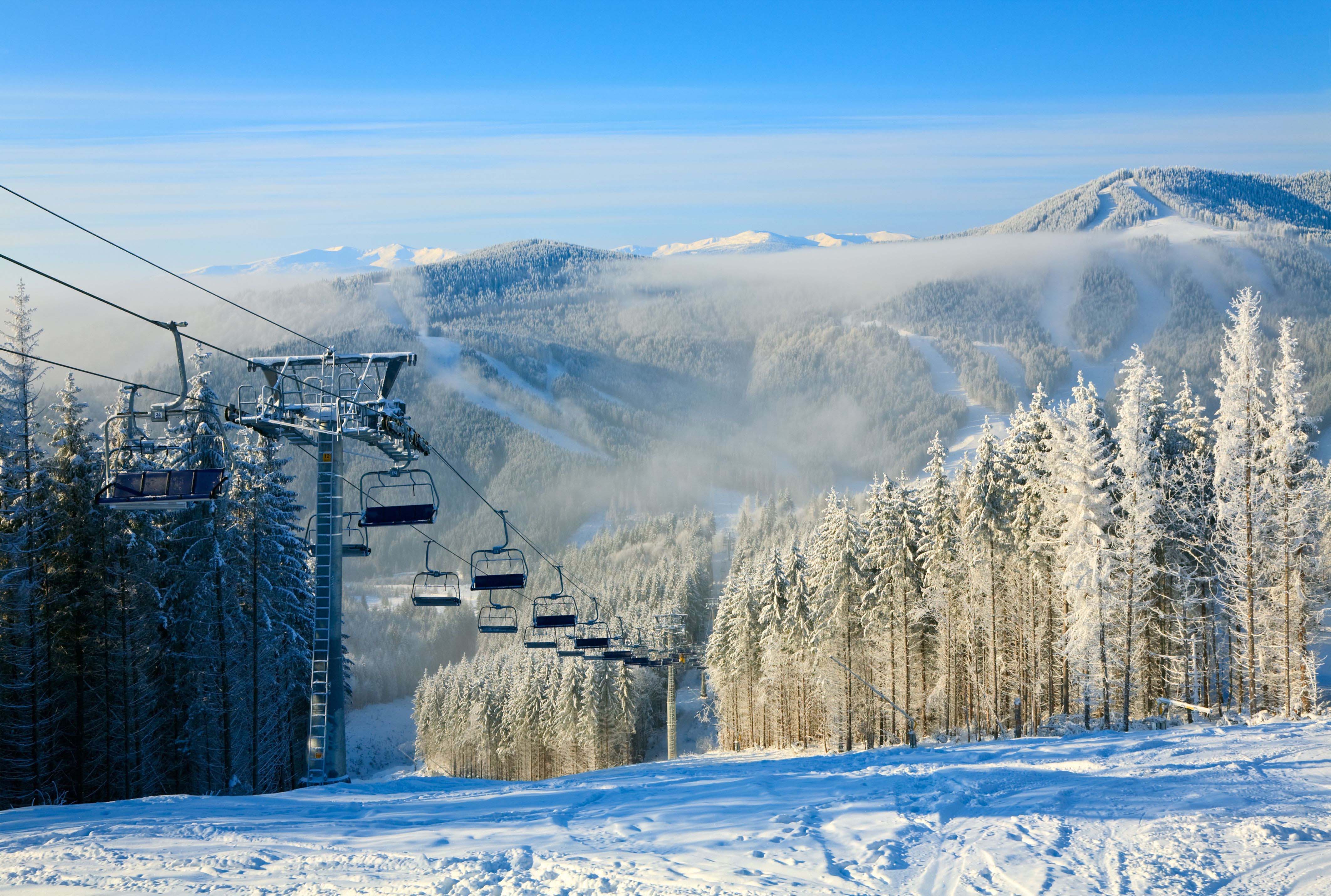 Travel to Brezovica - Snow-covered ski slope with beautiful scenery and winter mountains in the background