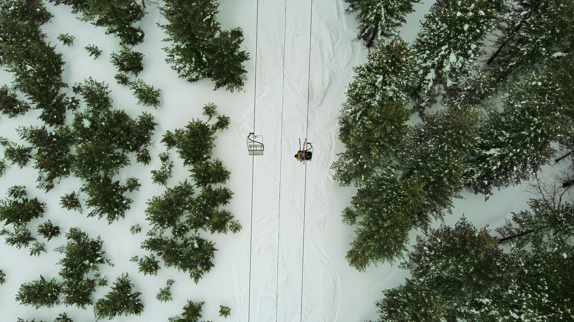 Bird's eye view on a lift with skiers over a ski slope in Brezovica, Kosovo