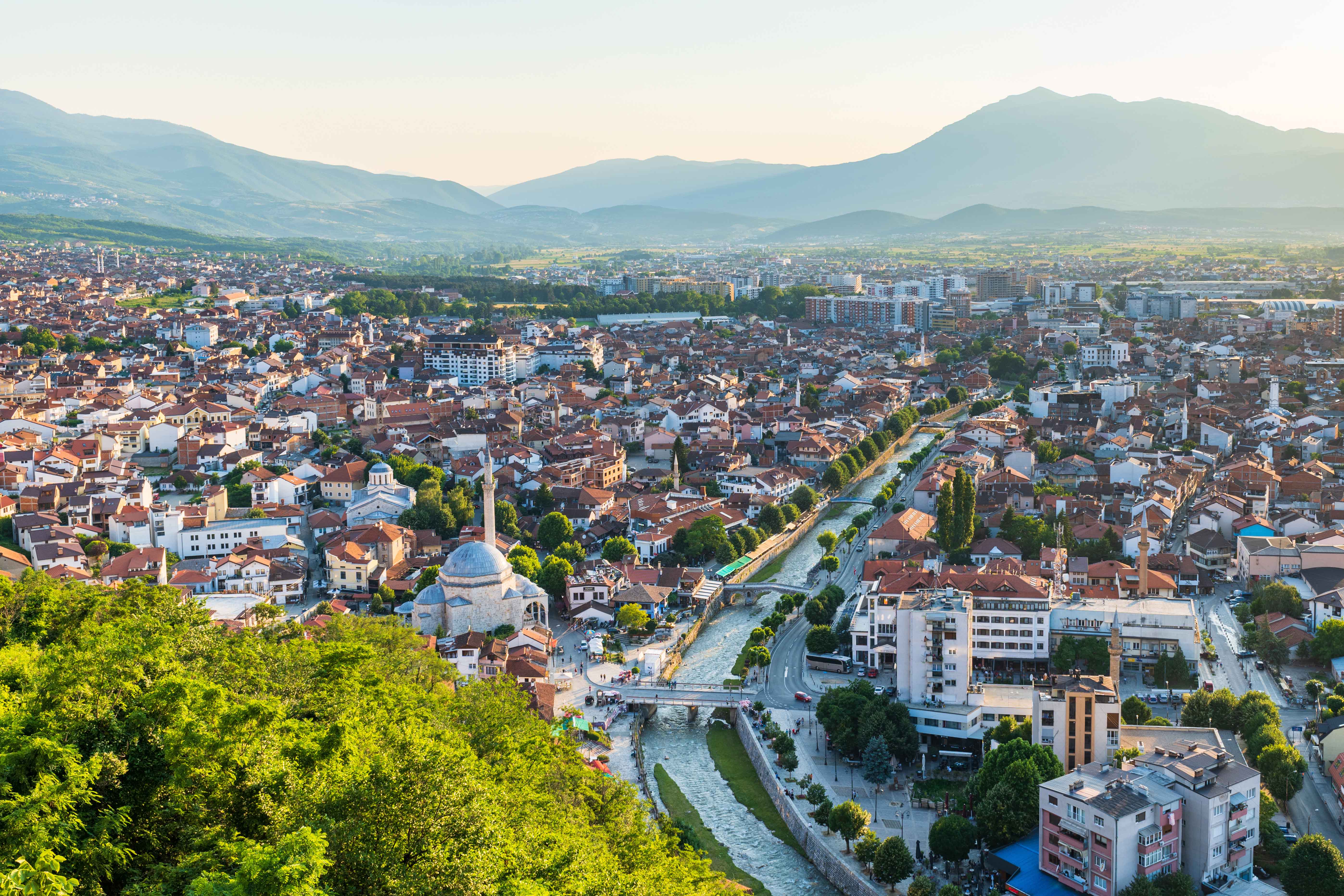 Travel to Kosovo - Panoramic view of lush city with mountains in the background of Kosovo