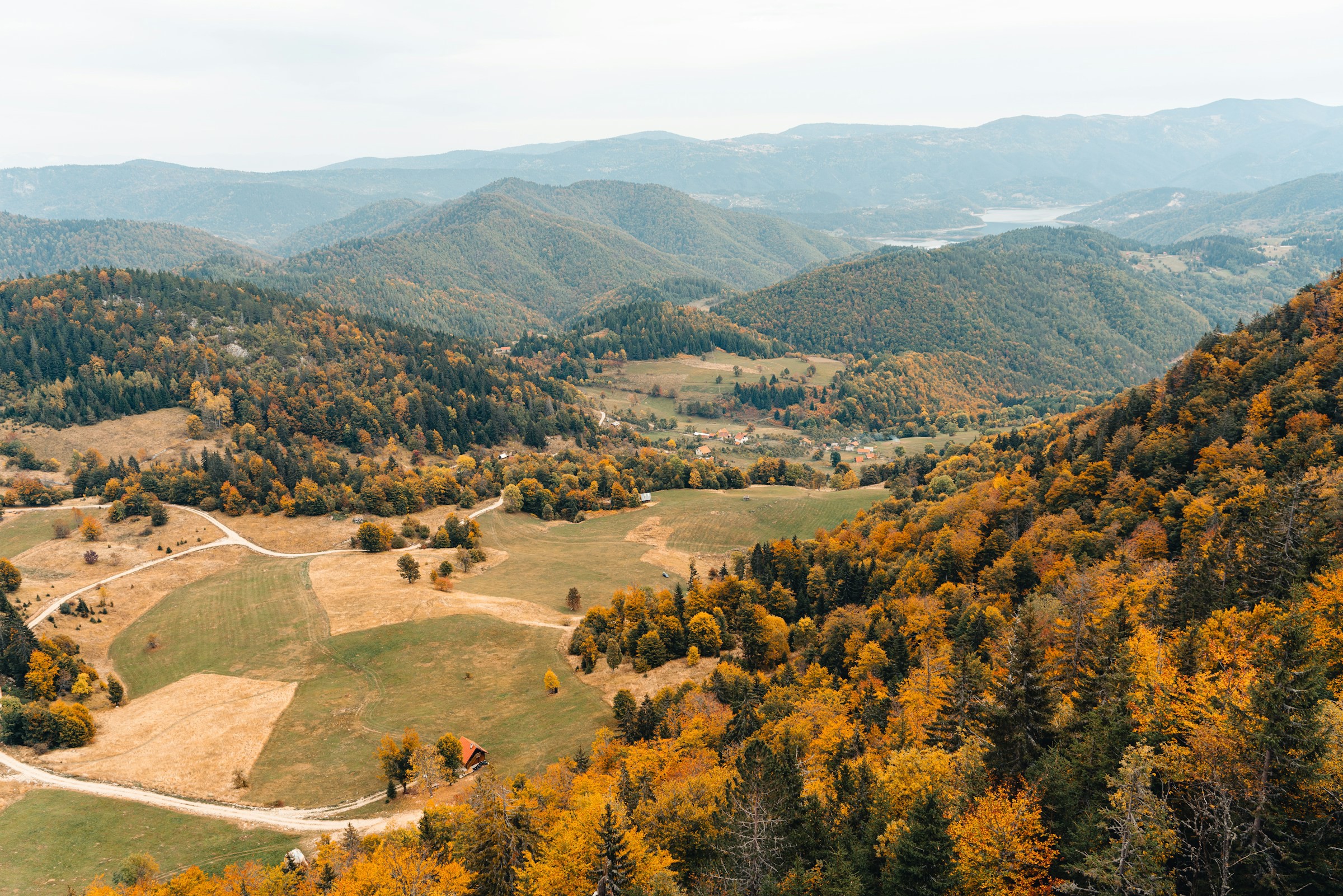 Bird's eye view of lush nature and forest with plains and mountains in the wilderness of Kosovo