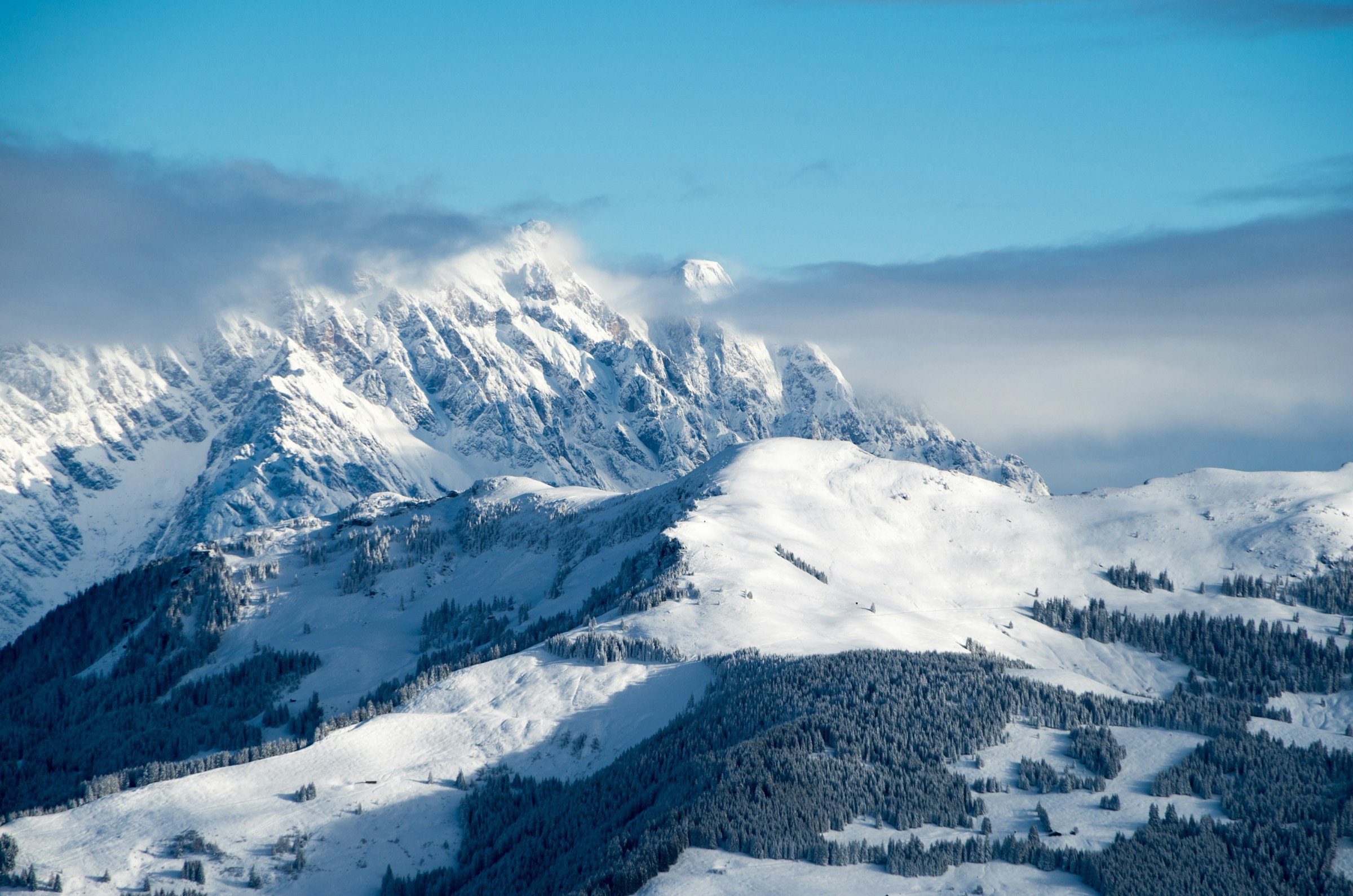 Snowy winter landscape and mountains with blue sky in the background in the ski resort of Zell am See, Austria