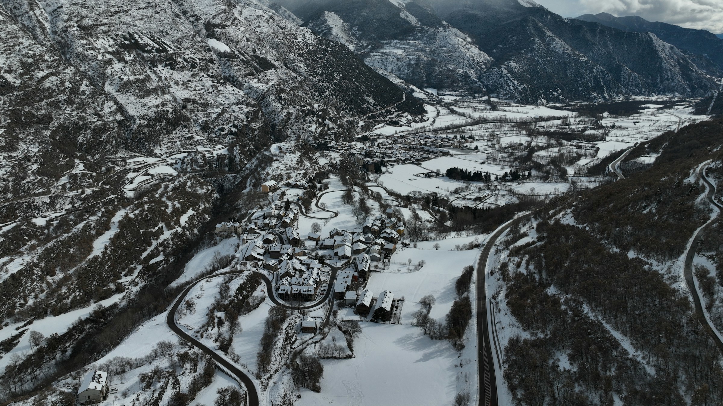 Snow-capped mountain walls between cliffs leading towards mountain peaks in Sierra Nevada, Spain